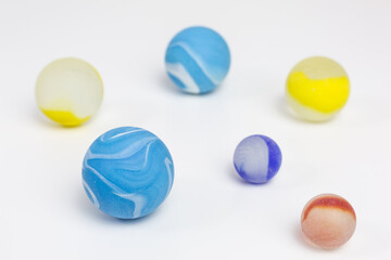 group of frosted glass marbles in blue, yellow and red