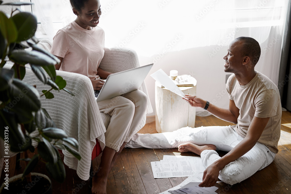 Wall mural attractive lovely couple work with documents and laptop, they have their own business, solve problem