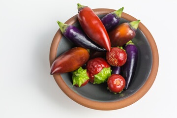 red and purple chili pepper in a bowl