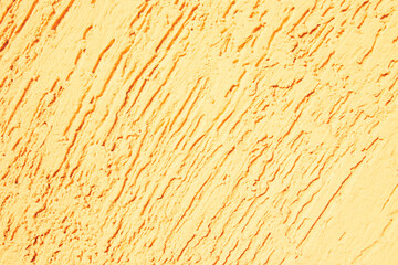 Fototapeta premium Yellow textured plaster. Deep unidirectional strokes on the plaster.