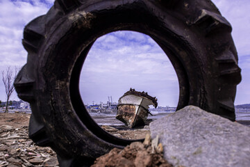  Abandoned and scrapped wooden fishing vessel lying on the beach.