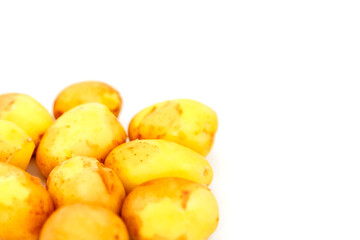 Naklejka na ściany i meble Raw potatoes on white background. Fresh potatoes on isolated. Early harvest. Washed vegetables. Selective focus. Concept of culinary skill. Place for an inscription or logo
