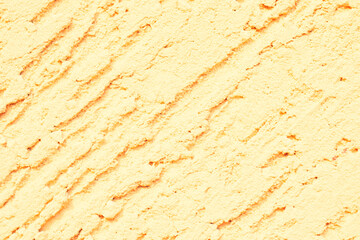 Yellow textured plaster. Deep unidirectional strokes on the plaster.