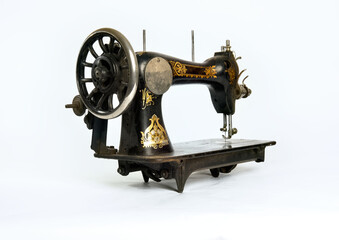 Old, historical sewing machine isolated against a white background