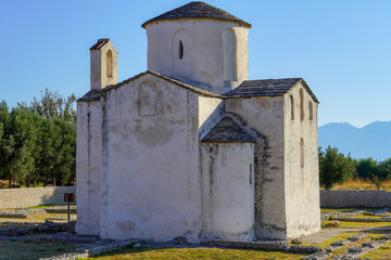 Fototapeta premium Medieval church of Holy Cross from 9th century and archaeological site in historic town of Nin, Dalmatia, Croatia