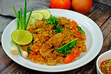 Authentic Thai old style fried rice in dark soy sauce served with spring onion, cucumber slices and lime.