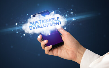 Female hand touching smartphone with SUSTAINABLE DEVELOPMENT inscription, cloud business concept