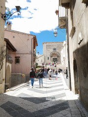 Fototapeta na wymiar Pescocostanzo - Abruzzo - Largo della Collegiata; at the end of the street the basilica of Santa Maria del Colle is visible.