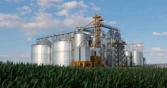 Modern Granary elevator. Silver silos on agro-processing and manufacturing plant for processing drying cleaning and storage of agricultural products, flour, cereals and grain. 