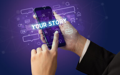 Female hand typing on smartphone with YOUR STORY inscription, social media concept