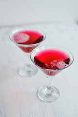 Pink sparkling cocktail standing on the white background