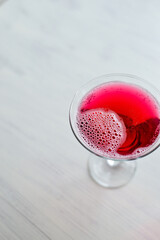 Pink sparkling cocktail standing on the white background