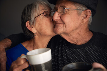 Happy senior couple kissing and laughing