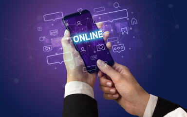 Female hand typing on smartphone with ONLINE inscription, social media concept