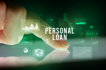 Finger touching tablet with charts and PERSONAL LOAN inscription, business concept