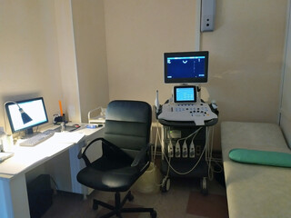 Medical diagnostic equipment, couch for examination, doctor's workplace. Ultrasonic diagnostic device. The monitor is blue. Diagnostics. The doctor's office. Medical topic. Copy space for text