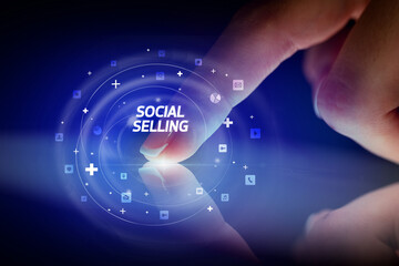 Finger touching tablet with social media icons and SOCIAL SELLING