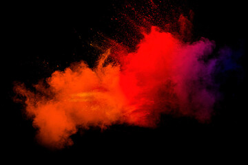Abstract blurred motion of colorful dust particles on black background.Abstract hot tone color powder overlay texture.