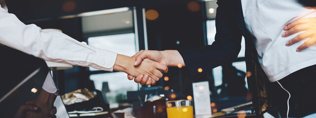 Business women shaking hands in the office. Finish successful, meeting room conference. Wide...