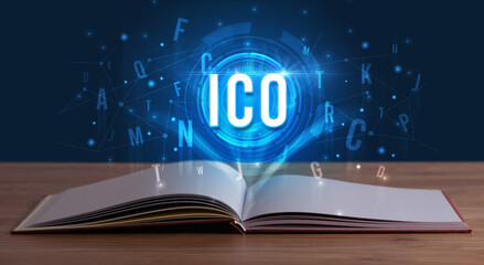 ICO inscription coming out from an open book, digital technology concept