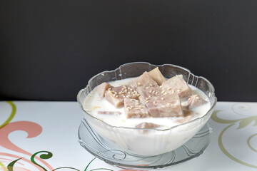 
Taro, cooked in coconut milk, in a serving cup on a white background - Powered by Adobe