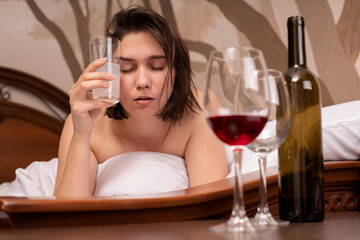 Sad woman suffering from hangover in morning