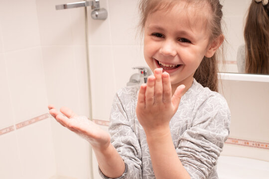 Child Washing Hands And Showing Soapy Palms