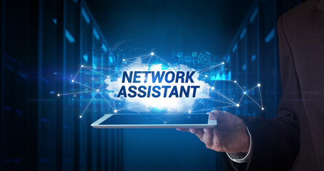 Young business person working on tablet and shows the inscription: NETWORK ASSISTANT