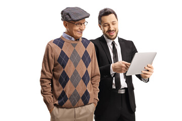 Professional man in a black suit showing a tablet to an elderly man