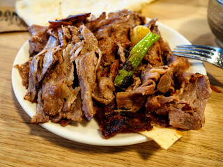 Turkish Doner Kebab on plate. Arabic traditional doner with pita bread / lavash. Protein nutrition, clean eating, diet concept. Turkish, greek or middle eastern style doner kebab food restaurant.