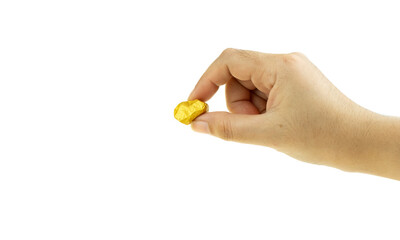 Woman hand holding gold nugget at the white background