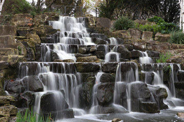 Obraz premium waterfall in the park, long exposure, stones and trees 