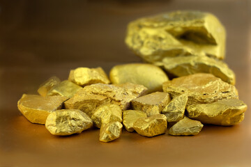 Group fo gold nugget at the golding background