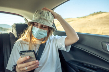 Girl with the smartphone in a car