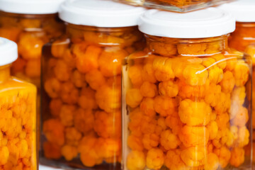 Jars of cloudberry jam. Cloudberry berry in a glass jar. Northern berry of yellow color