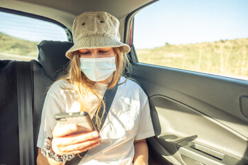 Girl with the smartphone in a car