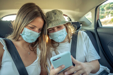 Girls with the smartphone in a car