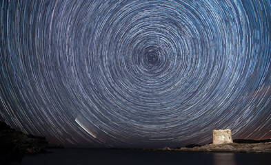 Star Trails with the neowise comet seen at La Pelosa beach, under the medieval tower in Stintino -...