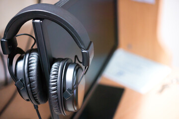 headphones for learn online on monitor laptop computer for e-learning or call center in client services and online support