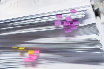 Fototapeta premium Paper stack, Pile of unfinished documents with post it on office desk related to business functions. Stack of business papers for Annual Report file