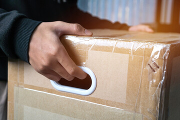 Messenger or deliveryman holding parcel box package to deliver customer at home. Delivery service...