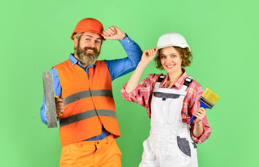 Pick color. DIY repair. Construction workers. Home renovation. Cheerful couple renovating house. Family nest. Painting walls. Woman builder hard hat. Man engineer or architect. Interior renovation