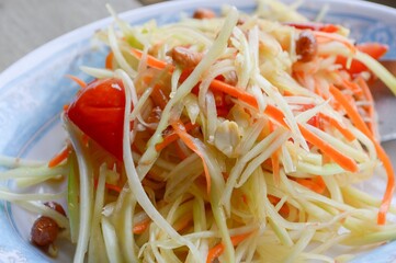 spicy papaya salad on wood floor - Thailand healthy food
