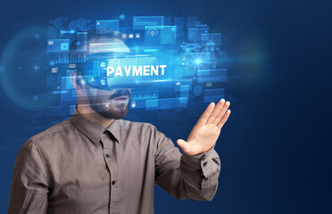 Businessman looking through Virtual Reality glasses with PAYMENT inscription, innovative security concept