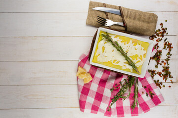 lasagna with rosemary cheese on wooden background