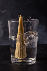 Baby corn in a glass of water