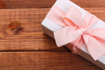 Beautiful gift box with altas bow on a vintage wooden board. holiday card concept.