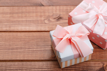 Beautiful gift box with altas bow on a vintage wooden board. holiday card concept.