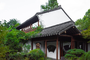 House among trees in Chinese garden in West Lake scenic area in Hangzhou, China