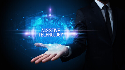 Man hand holding ASSISTIVE TECHNOLOGY inscription, technology concept